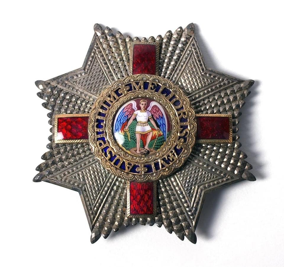Petitions And Calls For The Redesign Of Offensive Britain’s Highest Royal Honor, Which Depicts A Defeated Satan As Black Man In Chains