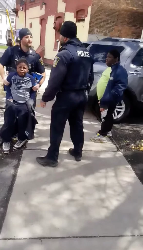 A group of Syracuse police officers detained an 8 year old African American Child for allegedly stealing a bag of Doritos